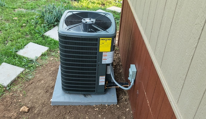 A newly installed central air conditioner outdoor compressor unit