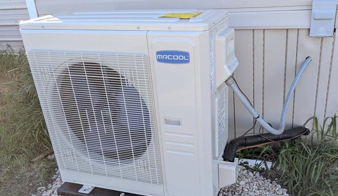 MrCool mini split condenser installed beside house