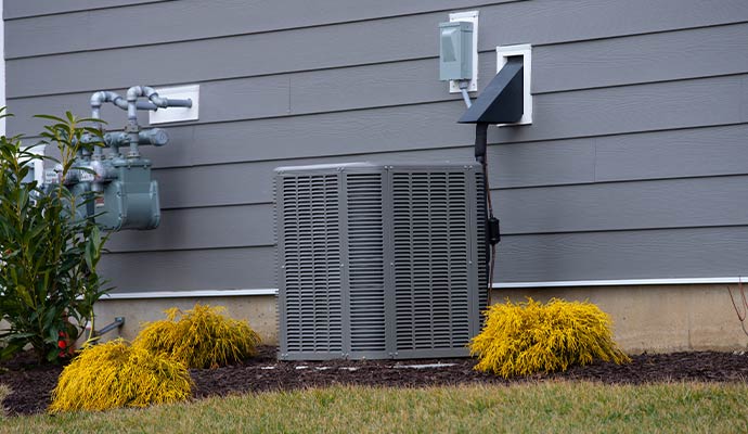 Outdoor AC unit installed beside a house