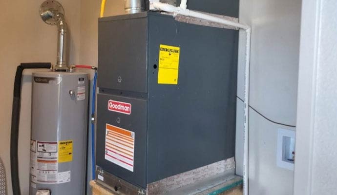 Water heater and Goodman furnace in utility room